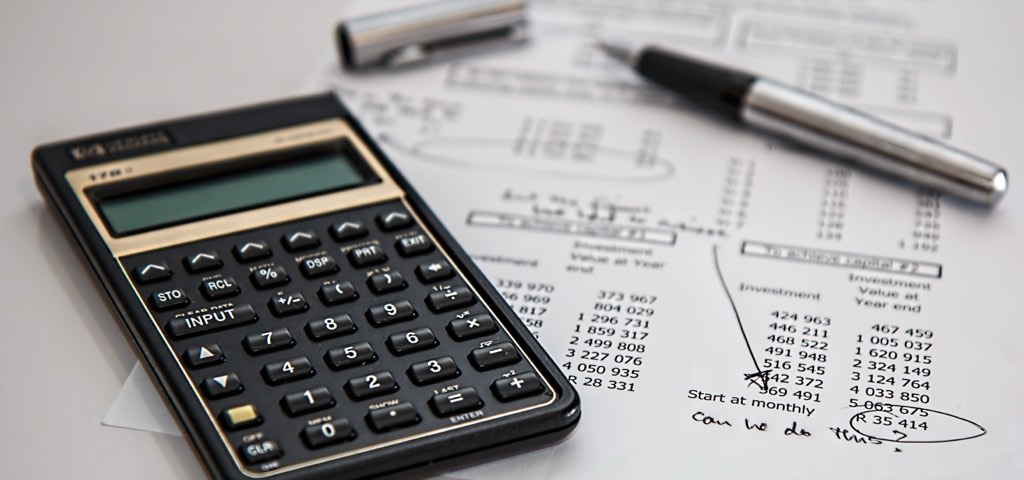 A calculator resting on printed financial documents