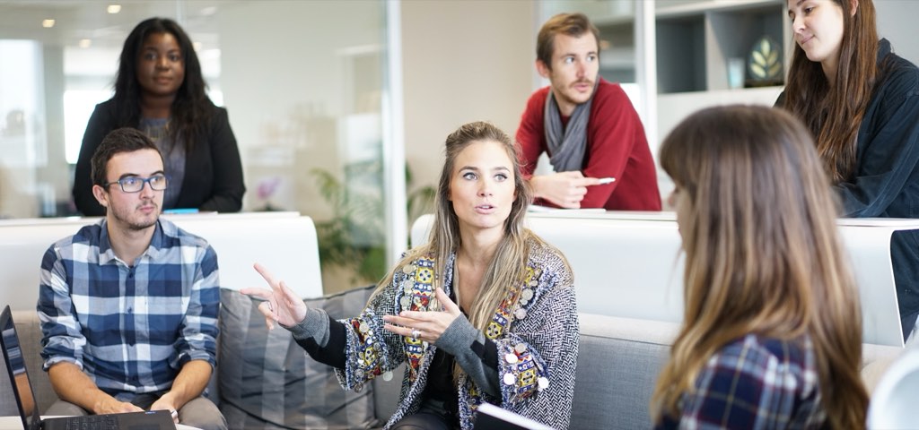 A team discussing figures around a meeting table